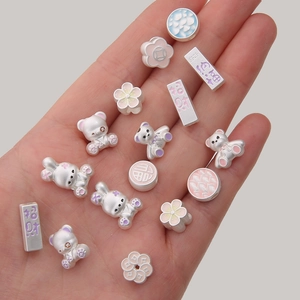 Macro shot of S925 silver DIY charms featuring enamel animals and auspicious patterns