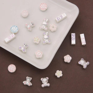 Macro shot of S925 silver DIY jewelry beads with rabbit and floral enamel details