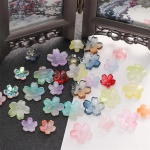 Detailed view of colorful 3D cherry blossom glass beads for DIY jewelry making