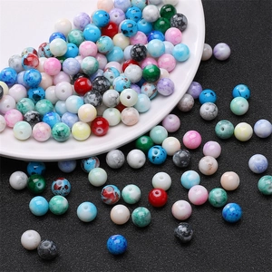 Close-up of 8mm marble-patterned glass beads for DIY jewelry making in multiple colors