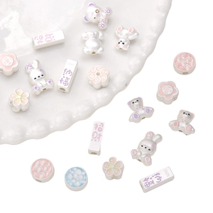 DIY S925 silver bear and rabbit charms with pink enamel detail on a ceramic dish