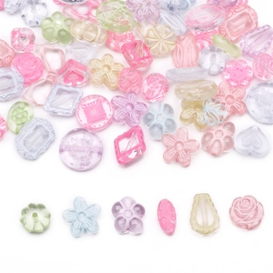 Macro shot of assorted colorful acrylic flower and heart beads for DIY jewelry making