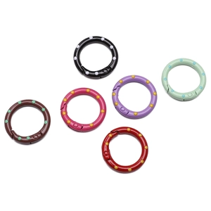 Detailed macro of 25mm colorful polka dot alloy spring O-rings for DIY crafts