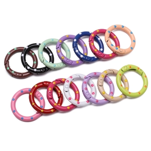 Close-up of colorful polka dot pattern alloy spring rings for DIY jewelry and bag hooks