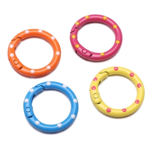 Detail view of four 25mm colorful polka dot alloy spring rings for DIY keychains