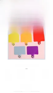 Close-up of colorful PVC phone tether tabs with reinforced metal eyelets in eight vibrant colors