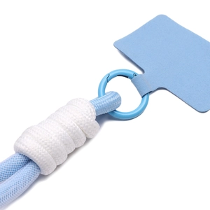 Macro detail of a light blue velvet phone lanyard patch with sturdy metal ring and woven rope