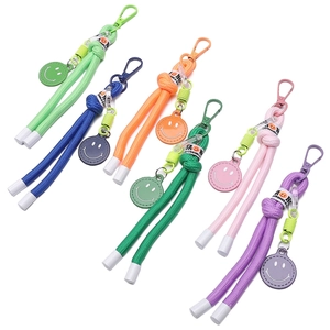 Portachiavi colorati in nylon intrecciato con ciondoli a faccina sorridente e moschettoni