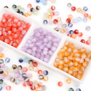 Colorful resin glitter beads in white ceramic tray for DIY jewelry making and crafts