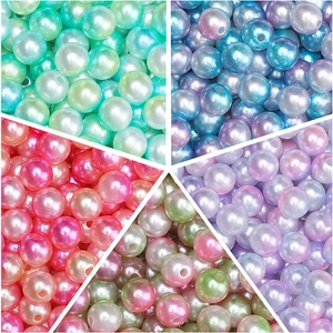 Macro detail of various colorful ABS pearls showing vibrant iridescent coating and drill holes