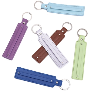 Macro detail of faux leather keychains with contrast stitching in diverse color options