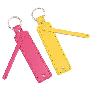 Detailed close-up of rose red and yellow leather keychains with silver metal rings