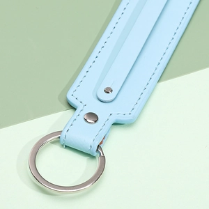 Light blue textured leather keychain with white stitching and silver metal ring