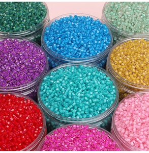 Macro shot of 4mm colorful glass seed beads in clear jars for DIY jewelry making
