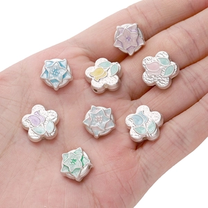 Handheld view of colorful tulip enamel flower beads for DIY jewelry making and charms