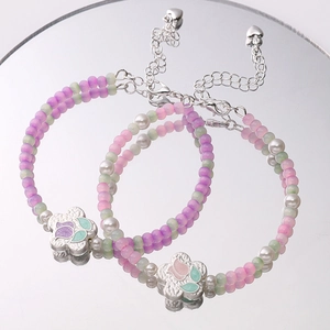 Silver tulip beaded bracelet with pink and purple matte pearls and floral metal charms