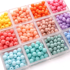 Macro view of colorful matte acrylic round beads for DIY jewelry making in storage box