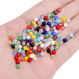 4mm round colorful glass seed beads for DIY jewelry making held in a hand for scale