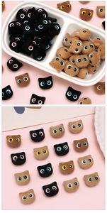 Macro detail of flocked cat head beads showing soft texture and colorful cartoon eyes