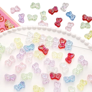 Macro view of colorful acrylic butterfly beads for handmade DIY jewelry crafting