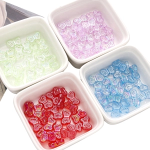 Macro view of colorful acrylic butterfly beads with aurora finish for DIY jewelry