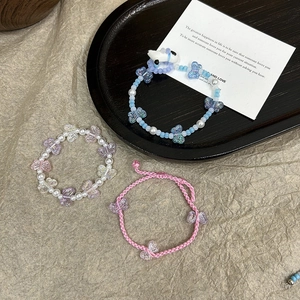 Detail of acrylic butterfly tulip beads and DIY charms for handmade bracelet making