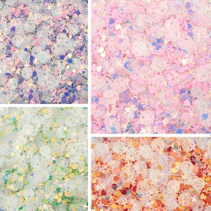 Macro detail of mixed holographic sequins in purple, pink, green, and orange for DIY jewelry
