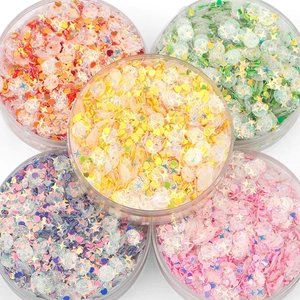 Mix of colorful star and heart sequins in plastic boxes for DIY jewelry making