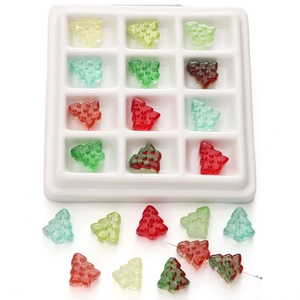 Macro detail of Christmas tree glass beads for DIY jewelry with colorful dot texture