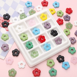 Colorful floral resin beads for DIY bracelets and necklaces in a grid display tray