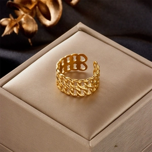 Detail of a gold plated hollow chain link ring with adjustable open band feature