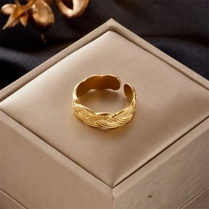Detailed view of adjustable gold plated ring with elegant braided metal texture design