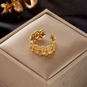 Close-up of gold-plated stainless steel ring with vintage hollow lace pattern design