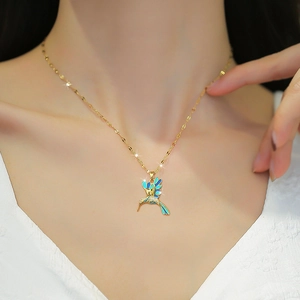 Elegant gold hummingbird necklace with blue enamel and sparkling micro-inlaid zircons