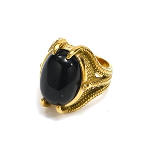 Detailed close-up of punk style ring featuring large black gemstone and eagle claw setting
