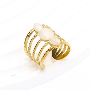 Macro shot of 18k gold plated multi-layer ring with opal gemstones and twisted textures