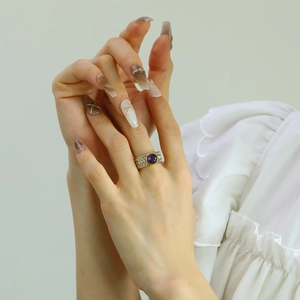 Gold plated titanium steel ring with a large round purple stone and pave-set zircons