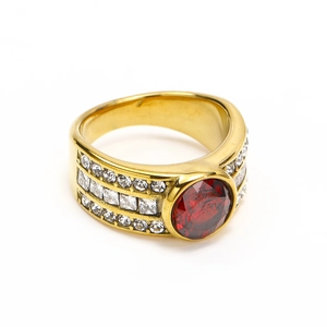 Macro detail of luxury gold titanium steel ring with large red zircon and pavé crystals