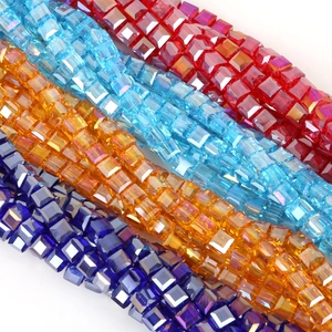 Close-up of 8mm faceted square glass crystal beads in red, blue, amber, and purple colors