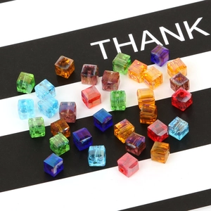 Macro detail of 8mm colorful crystal glass cube beads with precision center holes