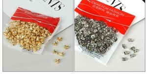 Detailed view of bulk gold and silver butterfly earring backs in transparent packaging