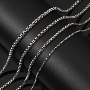 Macro shot of four different sizes of polished stainless steel box chains for jewelry making