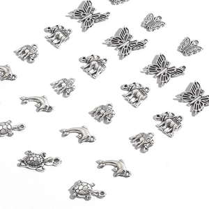 Assorted vintage alloy charms including elephant, butterfly, dolphin, and turtle shapes