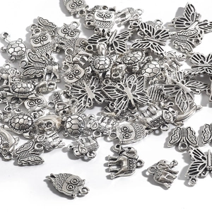 Collection of antique silver alloy animal pendants including owl elephant and turtle