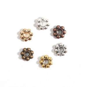 Set of six flower-shaped alloy spacer beads in various metallic finishes for DIY jewelry