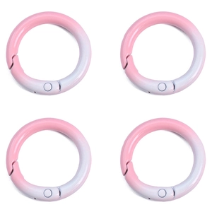 Close-up of four pink and white gradient alloy round spring buckles for DIY keychains