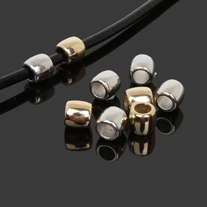 Close-up of gold and silver CCB barrel beads with large holes for DIY jewelry making
