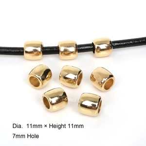 Macro detail of 11mm gold CCB barrel beads showing 7mm hole size for jewelry DIY