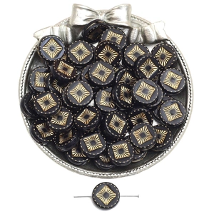 Close-up of vintage black acrylic flat beads with gold sunburst pattern and center hole