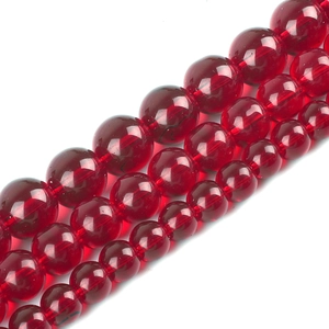 Detailed view of three strands of deep red transparent glass beads for DIY jewelry